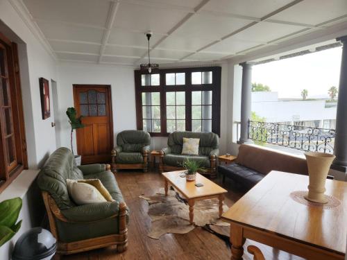 a living room with couches and a table at CasaMia in Bredasdorp