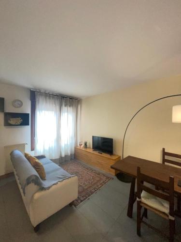 a living room with a couch and a table at Fonderia's Home - Parcheggia Senza Pensieri! in Treviso