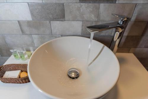a sink with water running from a faucet in a bathroom at Filenia in Hydra