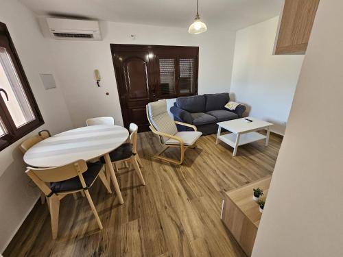 a living room with a table and a couch at Ático Alameda in Santa Cruz de la Palma