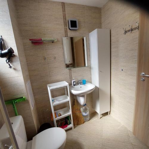 a small bathroom with a sink and a mirror at Sun Holidays Byala in Byala