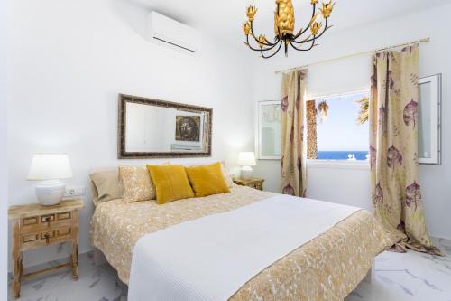a white bedroom with a bed and a window at Atlantic Dream with pool II in Puerto de Santiago