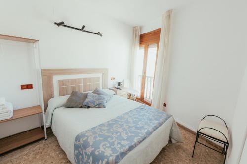 Ένα ή περισσότερα κρεβάτια σε δωμάτιο στο Hostal La Toba