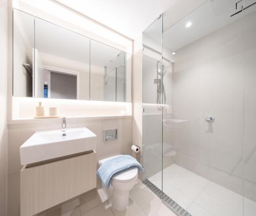 a bathroom with a toilet and a sink and a shower at Modern Urban Oasis in the Heart of Chinatown in Sydney