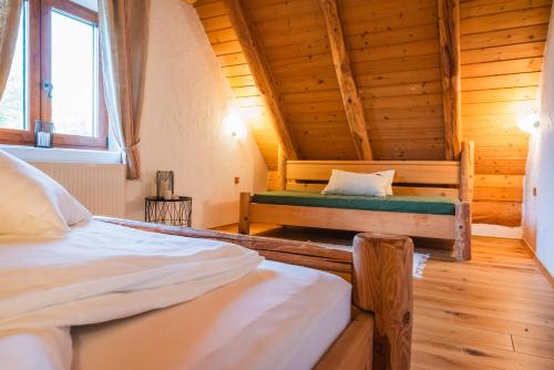 a bedroom with two beds in a log cabin at Kmečka Hiška - Hiša vina Cuk in Lendava