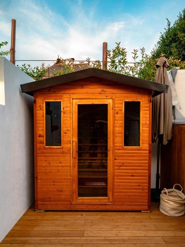 a small wooden dog house on a patio at Kmečka Hiška - Hiša vina Cuk in Lendava