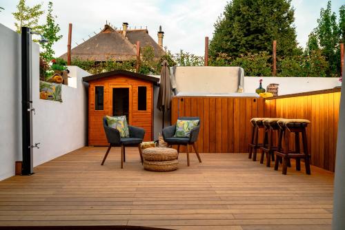 a patio with chairs and a dog house at Kmečka Hiška - Hiša vina Cuk in Lendava