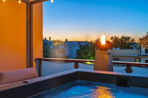 a hot tub on a balcony with a view at Majestic Villa overlooking Acropolis with Hot Tub in Athens