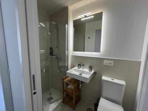 a bathroom with a toilet and a sink and a shower at Beach House Costa Ballena in Chipiona