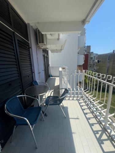 a balcony with chairs and tables on a building at Andjela’s Apartment in Igalo