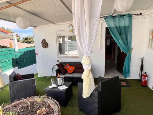 a living room with two chairs and a couch at A Casinha in Carreira do Mato
