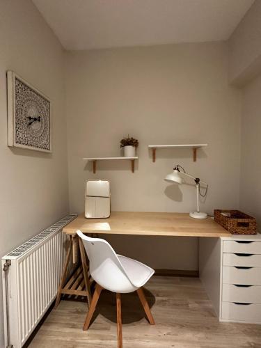 a desk with a white chair in a room at Chálari in Raches