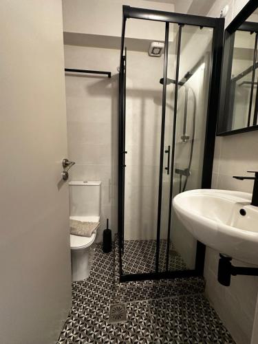 a bathroom with a shower and a toilet and a sink at Chálari in Raches