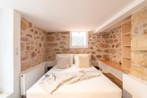 two beds in a small room with brick walls at Majestic Villa overlooking Acropolis with Hot Tub in Athens