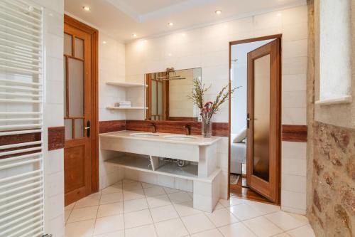 a bathroom with a sink and a mirror at Majestic Villa overlooking Acropolis with Hot Tub in Athens