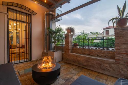 a patio with a table and a balcony at Majestic Villa overlooking Acropolis with Hot Tub in Athens