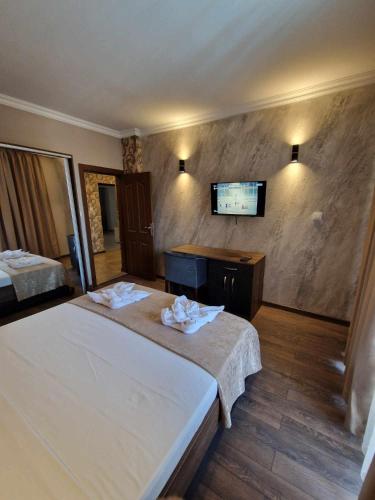 a hotel room with two beds and a flat screen tv at MitProt Panorama Bay 2 Luks Apartment 110 in Sveti Vlas