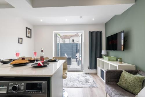 a kitchen and living room with a table and a couch at Luxury Apartments in Cardiff City Centre in Cardiff