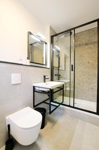 a bathroom with a toilet and a sink and a shower at Feel Good in Ravna Gora