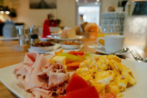 a white plate of food on a table at KRACHER Apartment No 1 - inklusive Pool in Illmitz