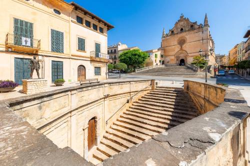 a set of stairs leading to a building with a statue at Can Manuel in Felanitx