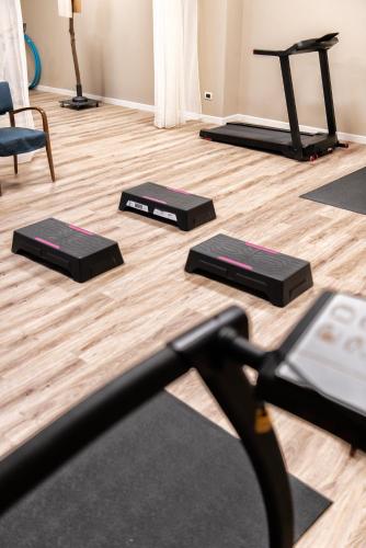 a gym with three yoga mats on the floor at CallMe Crema - Struttura in centro storico in Crema