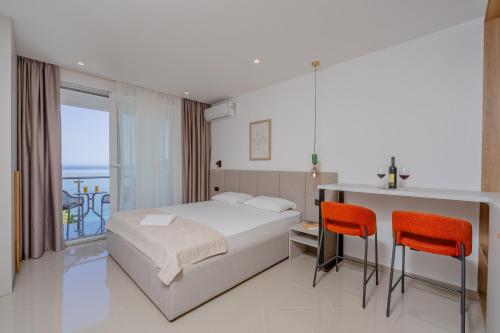 a hotel room with a bed and a balcony at Bliss Apartments in Sutomore