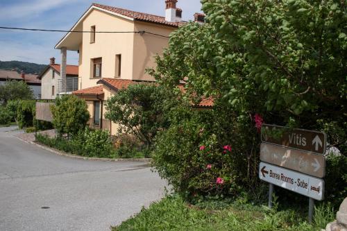 a street sign in front of a house at Borea Rooms - Sobe Budanje in Vipava