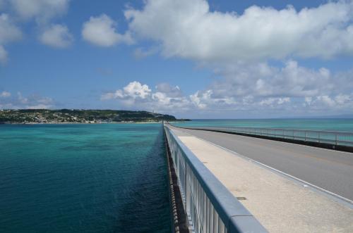 a bridge over a body of water at Guest House Isa in Motobu
