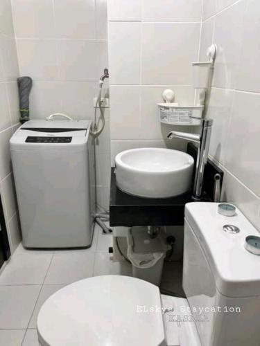 a small bathroom with a toilet and a sink at Kasara Urban Residences - Cozy Studio Unit in Manila