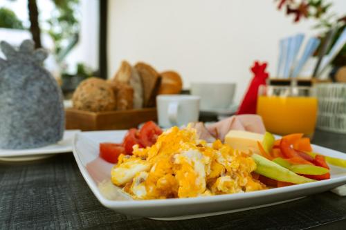 a plate of food with vegetables on a table at KRACHER Guesthouse No 8 - inklusive Pool in Illmitz
