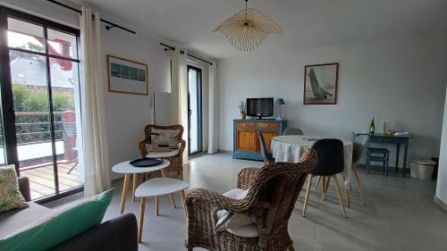 una sala de estar con una mesa y sillas en Les Voiles du Clipper T2, en Préfailles