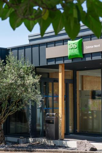 a building with a hicks clinic sign in front of it at Ibis Styles Colmar Nord in Colmar