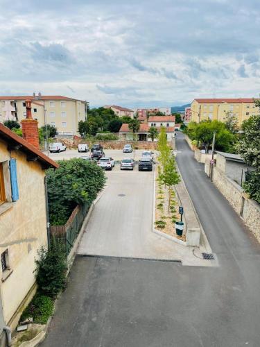 a street with cars parked in a parking lot at Verrières 2 in Issoire