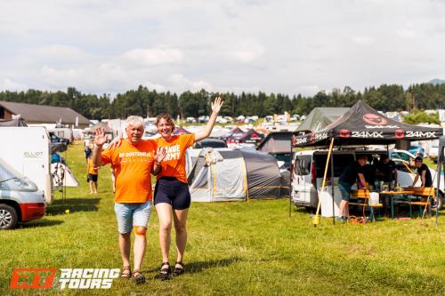 two people walking through a field with tents at RacingTours RaceCamp - Spielberg in Spielberg