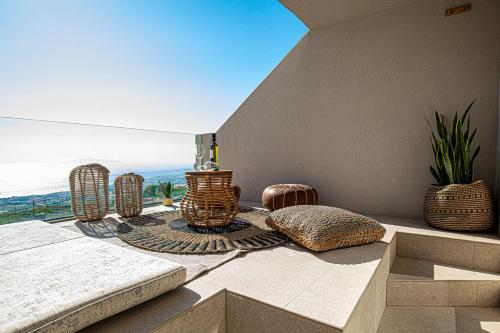 a balcony with a table and a view of the ocean at Divelia East in Imerovigli