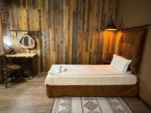 a bedroom with a bed and a table and a mirror at The Forest Villa Borovets by BookVillaBG in Borovets