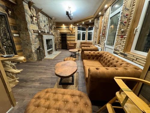 a waiting room with couches and a fireplace at The Forest Villa Borovets by BookVillaBG in Borovets