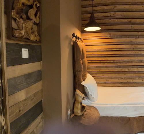 a room with a bed with a head board at The Forest Villa Borovets by BookVillaBG in Borovets