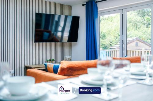 a living room with a couch and a television at Spacious Detached Bungalow By Harperletting Short Lets & Serviced Accommodation Buckely With Pool table & Driveway in Buckley