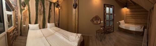 a bedroom with a white bed in a room at The Forest Villa Borovets by BookVillaBG in Borovets