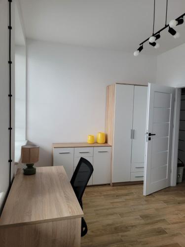 a room with a desk and a table and a door at Axo-Hostel 9 in Stalowa Wola
