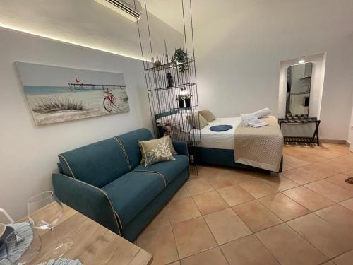 a living room with a couch and a bed at Ostuni Ayla Apartments in Villanova di Ostuni