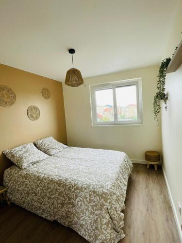 a bedroom with a bed and a window at Verrières 3 in Issoire