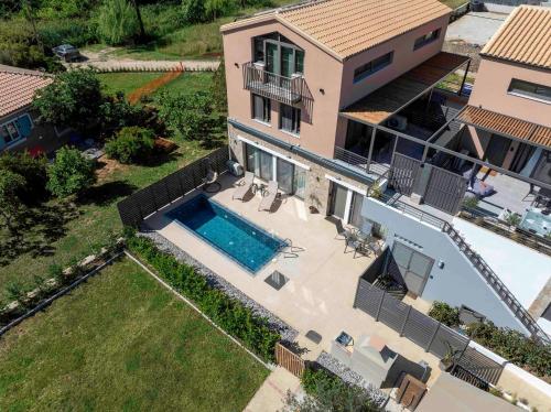 an aerial view of a house with a swimming pool at Argeno Suites Lefkada in Lefkada Town