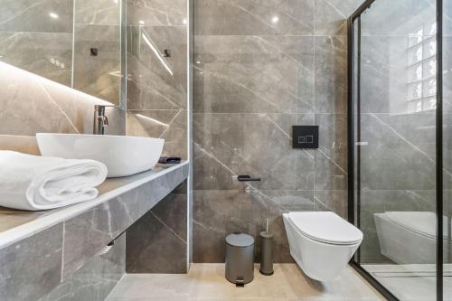 a bathroom with a sink and a toilet at Argeno Suites Lefkada in Lefkada Town
