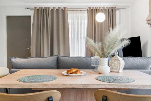 a table with a plate of food on top of it at Argeno Suites Lefkada in Lefkada Town