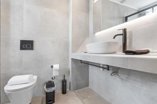 a bathroom with a sink and a toilet at Argeno Suites Lefkada in Lefkada Town