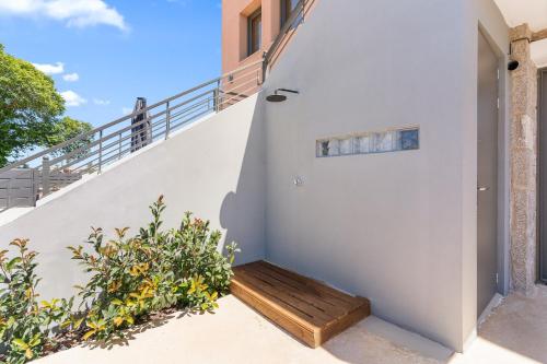 a staircase with a wooden bench in a house at Argeno Suites Lefkada in Lefkada Town
