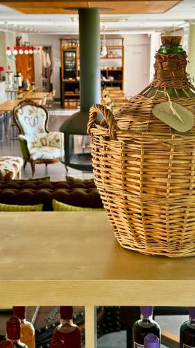 a basket sitting on top of a table with wine bottles at Artemisia Boutique Hotel in Bastelica